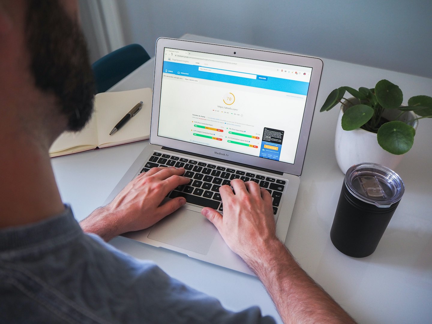 Bearded person analyzing website performance on laptop.